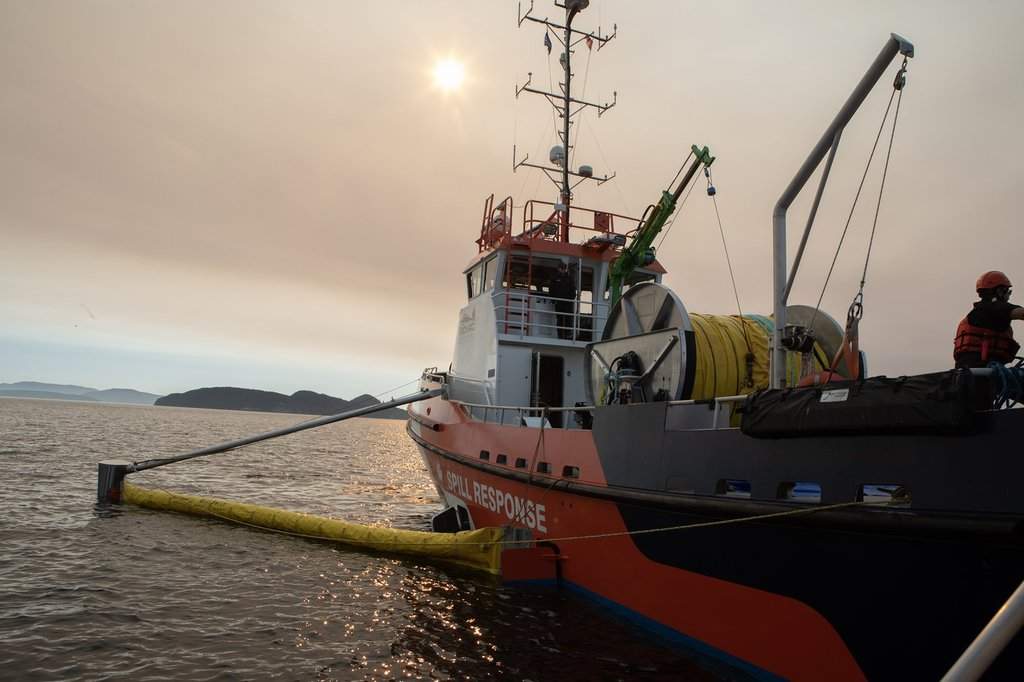 Crew prepare to deploy an offshore containment boom while aboard the skimming vessel the Hecate Sentinel during a Western Canada Marine Response Corporation joint training exercise off the coast Moresby Island, B.C., on Wednesday, Sept. 17, 2025. THE CANADIAN PRESS/Chad Hipolito.