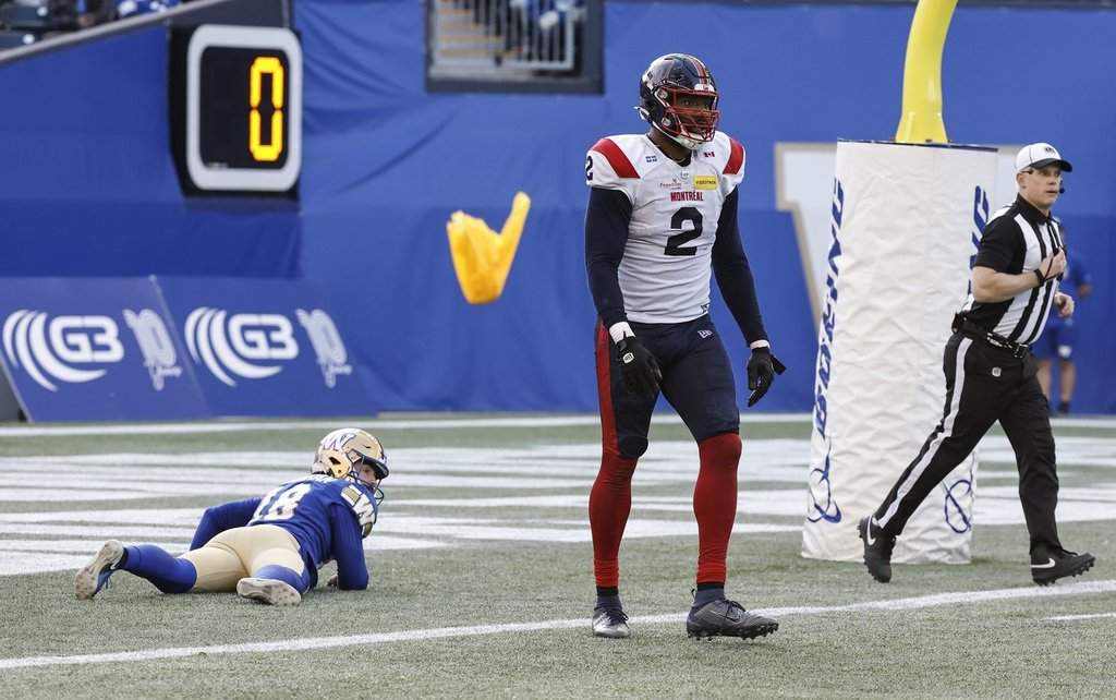 Montreal Alouettes' Shawn Oakman (2) gets called for roughing the passer as Winnipeg Blue Bombers' kicker Jamieson Sheahan (18) lies in his end zone during second half CFL action in Winnipeg Saturday, October 25, 2025.    THE CANADIAN PRESS/John Woods.