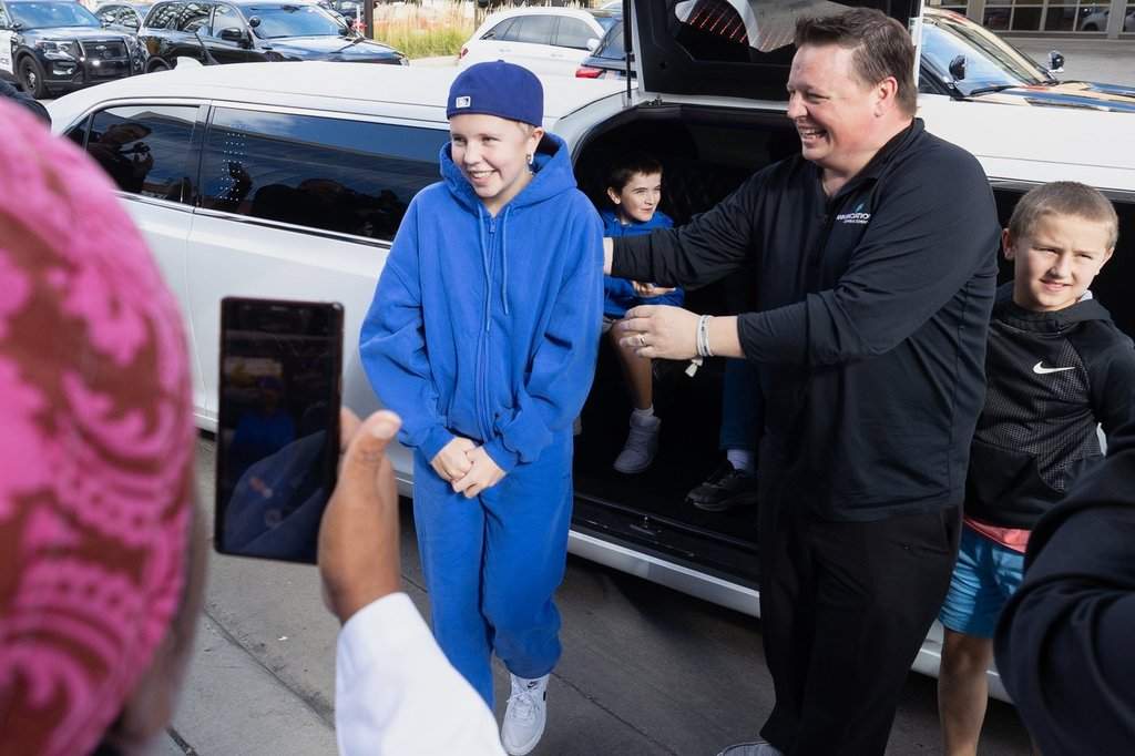 In this photo provided by the Catholic Spirit/Archdiocese of Saint Paul and Minneapolis, Sophia Forchas, an Annunciation Church and School mass shooting victim, and her father, Tom Forchas, right, arrive at the Hennepin County Medical Center on Thursday, Oct. 23, 2025, in Minneapolis. (The Catholic Spirit/Archdiocese of Saint Paul and Minneapolis via AP).
