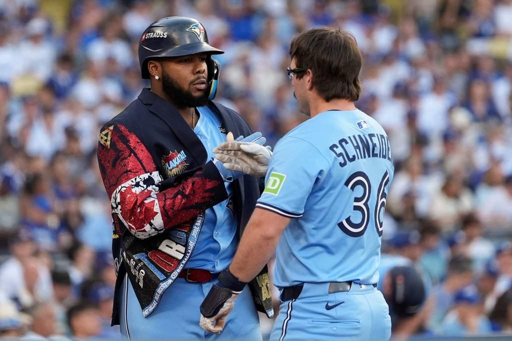 Toronto Blue Jays’ Davis Schneider (36) celebrates with Vladimir Guerrero Jr. after their back-to-back home runs during the first inning in Game 5 of baseball’s World Series against the Los Angeles Dodgers, Wednesday, Oct. 29, 2025, in Los Angeles.