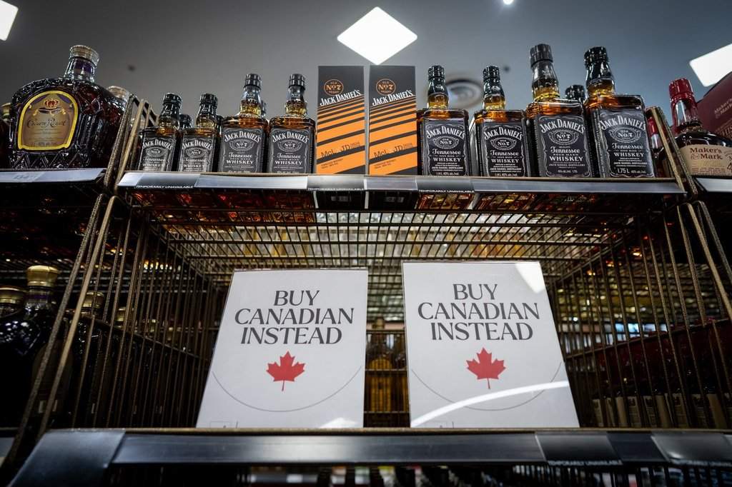 A sign is placed in front of the American whiskey section at a B.C. liquor store before top selling American made products are to be removed from shelves as a demonstration for media in Vancouver, B.C., Sunday, Feb. 2, 2025. THE CANADIAN PRESS/Ethan Cairns.