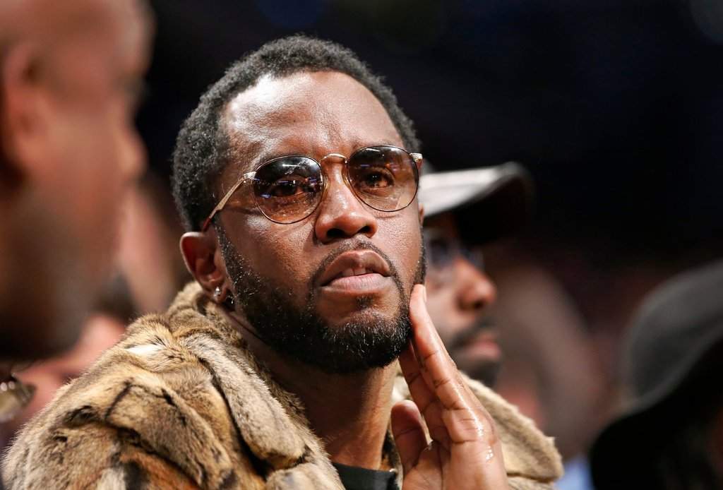 Sean 'Diddy' Combs sits courtside in the second half of an NBA basketball game between the Brooklyn Nets and the New York Knicks, March 12, 2017, in New York.