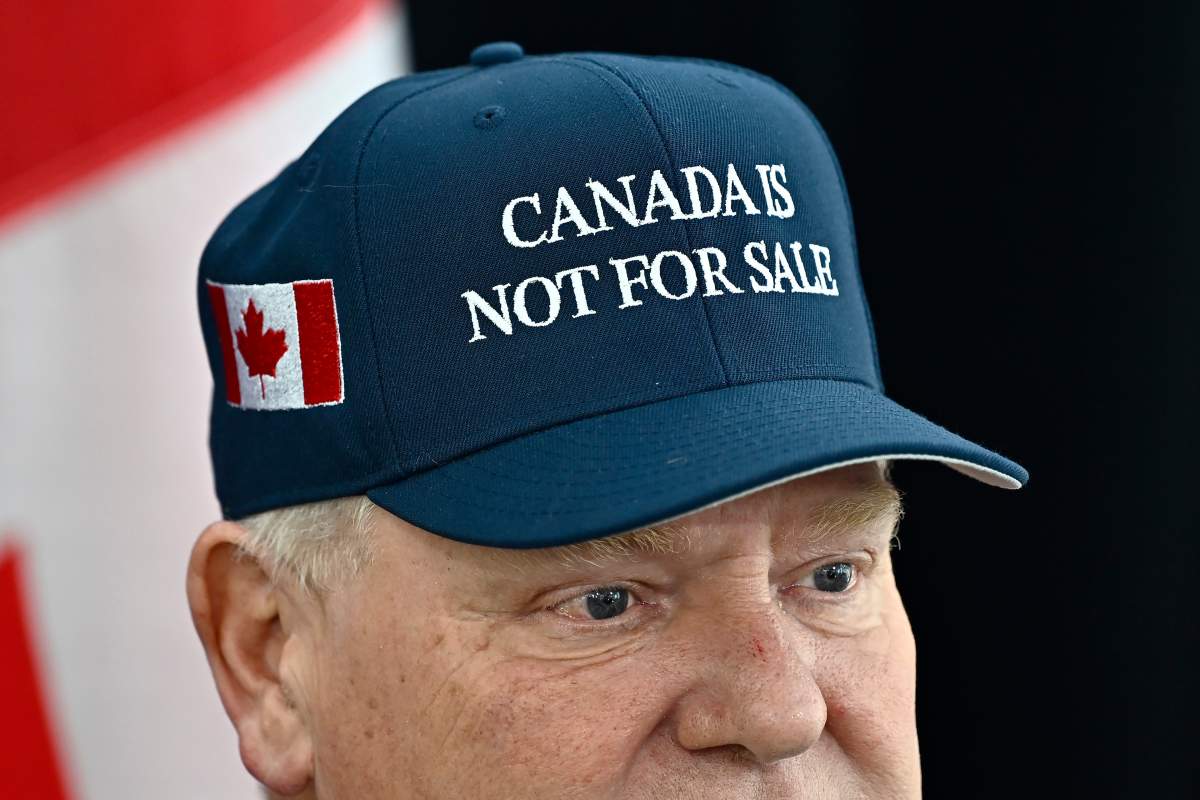 Ontario Premier Doug Ford, wearing a 'Canada Is Not For Sale' hat, speaks as he arrives for a first ministers meeting in Ottawa on Jan. 15.