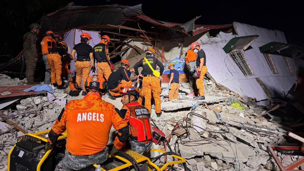 Rescuers search for survivors underneath rubble in Bogo, Philippines, Wednesday, Oct. 1, 2025.