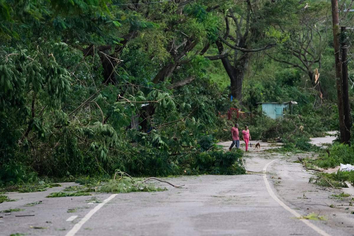 People walk along a road after Hurricane Melissa passed through Spurr Tree, Jamaica, Wednesday, Oct. 29, 2025.