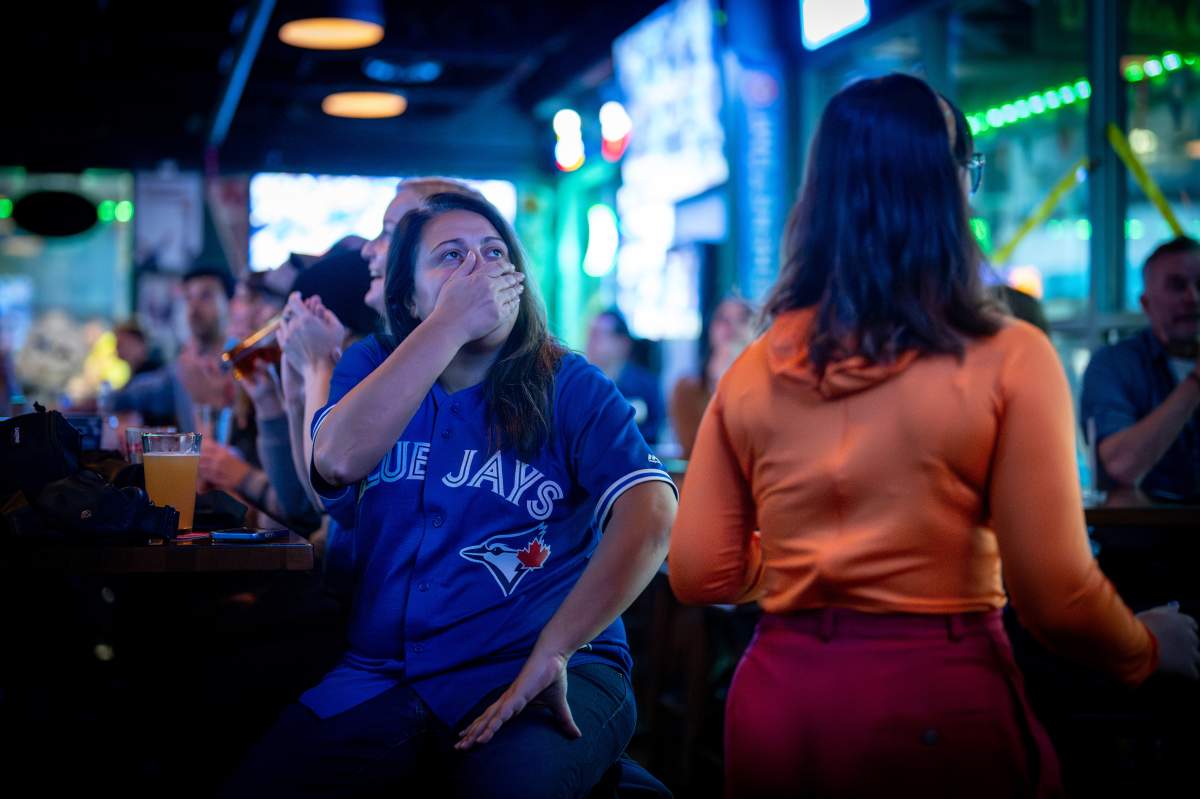 A Toronto Blue Jays fan reacts while watching Game 6 of the Word Series against the Los Angeles Dodgers at a bar in Vancouver, B.C., on Friday, October 31, 2025.