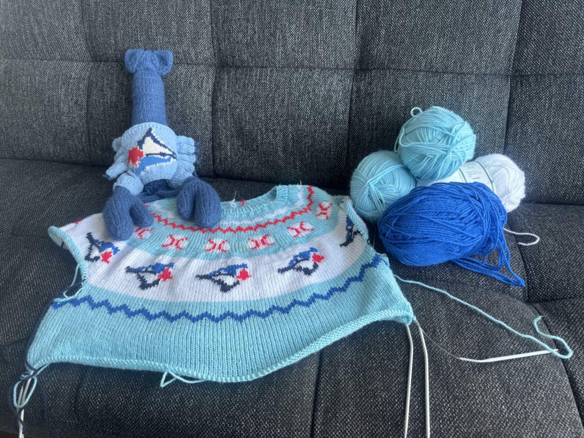 Knitting a Blue Jays sweater for a lobster was the first step, before taking on the challenge of a playoff sweater — only to be worked on during game days.