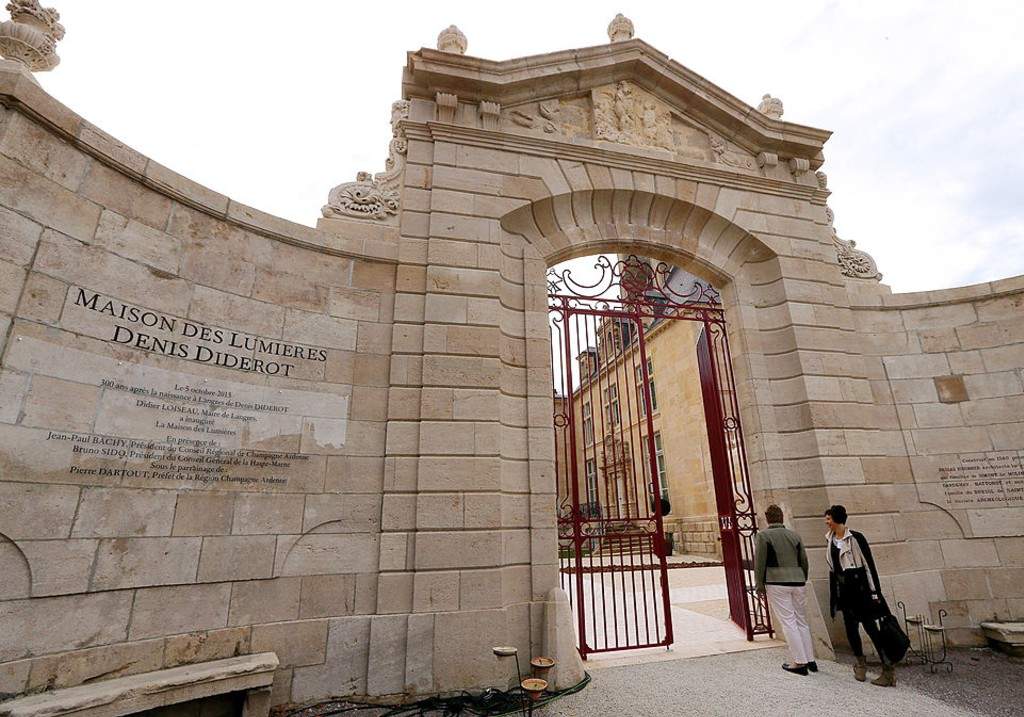 People stand outside the entrance of 'La Maison des Lumieres' (the House of the Enlightenment) on October 4, 2013 in in Langres, central France,