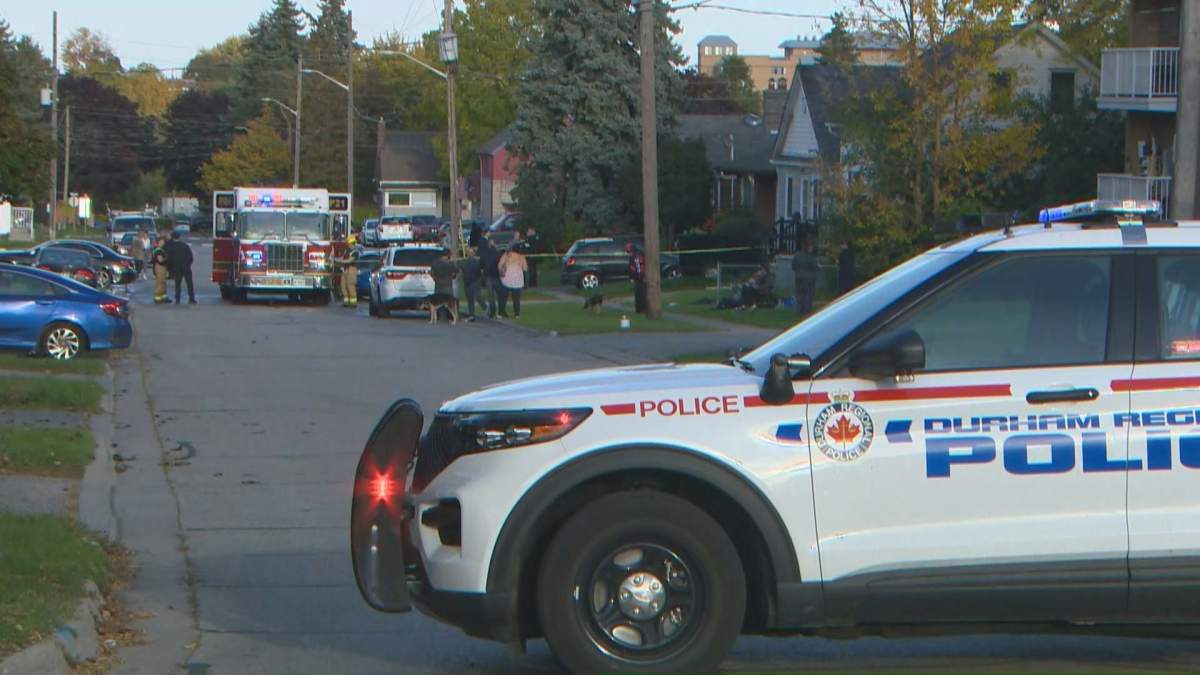 A Durham Regional Police vehicle sits near the scene of a trailer fire in which one child died and two other people were injured. 