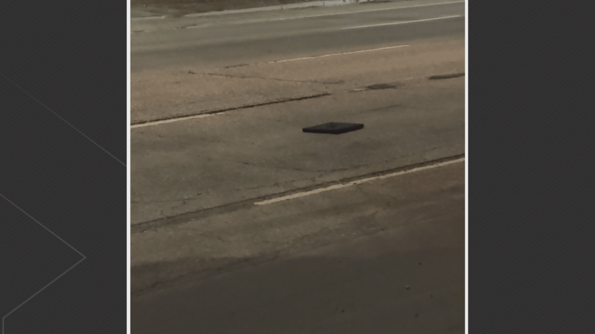A rubber base from a traffic post lies in traffic