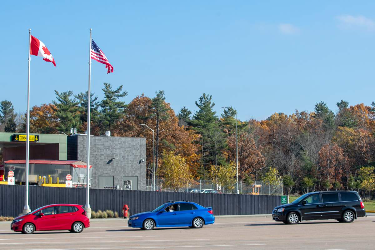 Vehicles wait to enter Canada from the U.S. at the U.S.-Canada border crossing at the Thousand Islands border in Lansdowne, Ont., on Monday, Nov. 8, 2021.