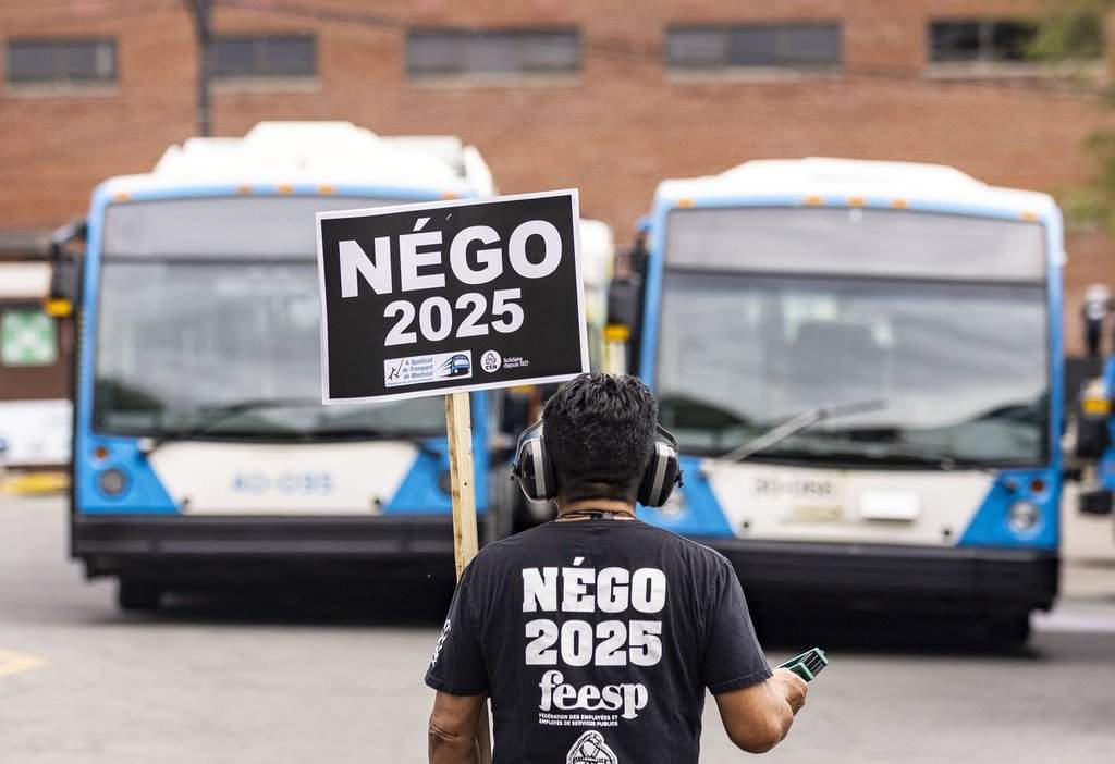 A Societe de transport de Montreal (STM) mechanic protests outside their facility in Montreal, Monday, Sept. 22, 2025.