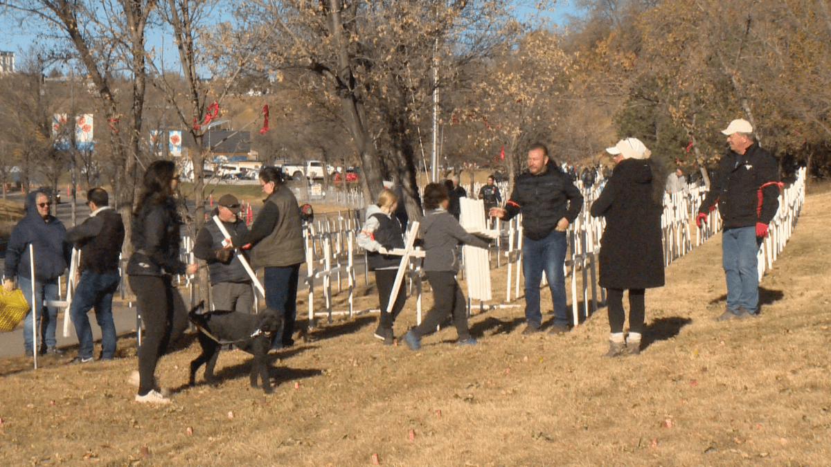 Volunteers set up for the annual field of crosses