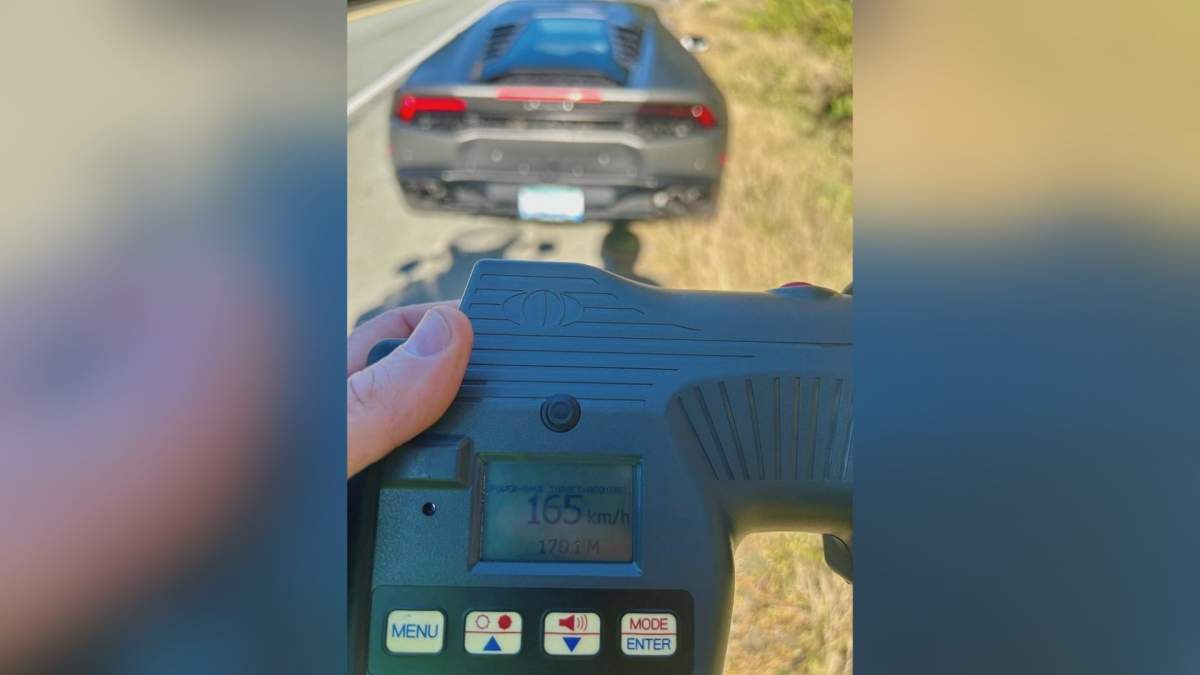 A B.C. Highway Patrol officer is pictured holding a speedometer that shows that a Lamborghini Huracán, pictured in the background, went 165 km/h in an 80 km/h zone on Oct. 13, 2025.