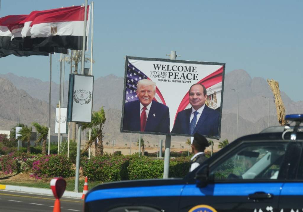 A police vehicle in front of a poster showing Egyptian President Abdel-Fattah el-Sissi and U.S. President Donald Trump at the Red Sea city of Sharm el-Sheikh, Egypt, Monday, Oct. 13, 2025.