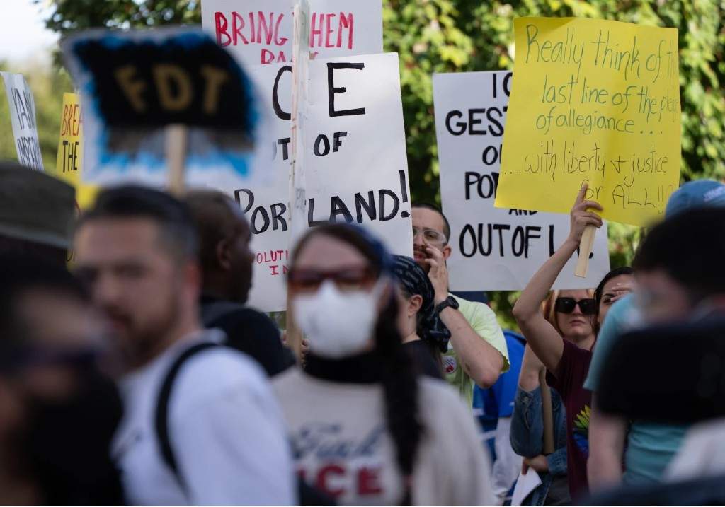 People protest outside a U.S. Immigration and Customs Enforcement facility on Sunday, Sept. 28, 2025, in Portland, Ore.