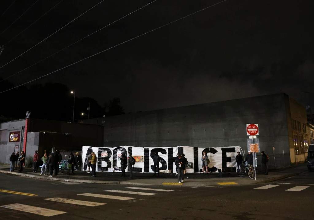 People protest outside a U.S. Immigration and Customs Enforcement facility, in Portland, Oregon, Wednesday, Oct. 1, 2025.