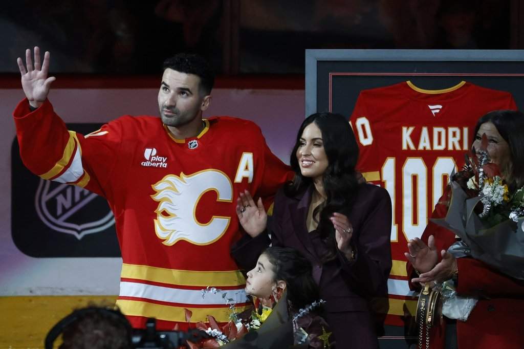 Calgary Flames' Nazem Kadri is honoured with a silver stick for his 1000th NHL game alongside his wife Ashley Cave and daughter Naylah prior to game action against the Columbus Blue Jackets in Calgary on Wednesday, Nov. 5, 2025.