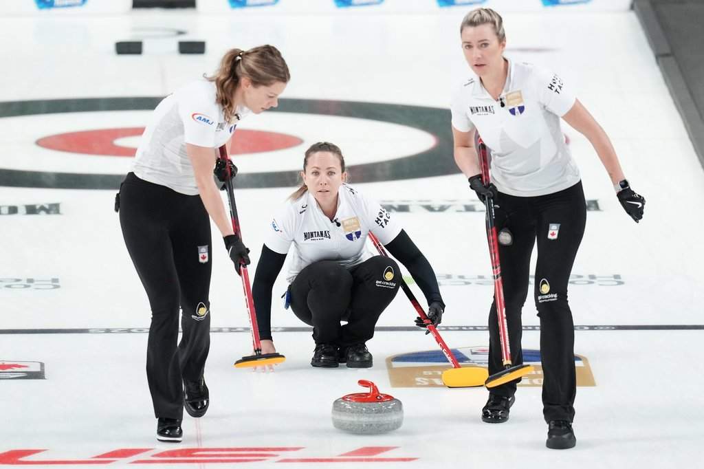 Rachel Homan, centre, throws a rock during Canadian Olympic curling trials action against Team Brown in Halifax, Tuesday, Nov. 25, 2025. THE CANADIAN PRESS/Darren Calabrese.