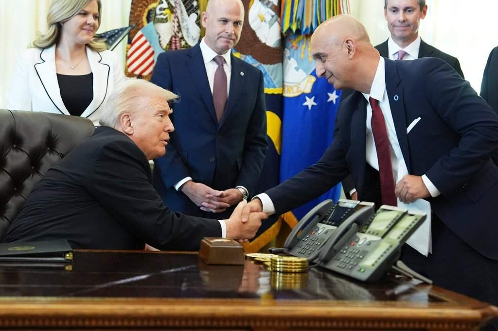 President Donald Trump, left, shakes the hand of Novo Nordisk President and CEO Mike Doustdar during an event about drug prices, Thursday, Nov. 6, 2025, in the Oval Office of the White House in Washington. (AP Photo/Evan Vucci).