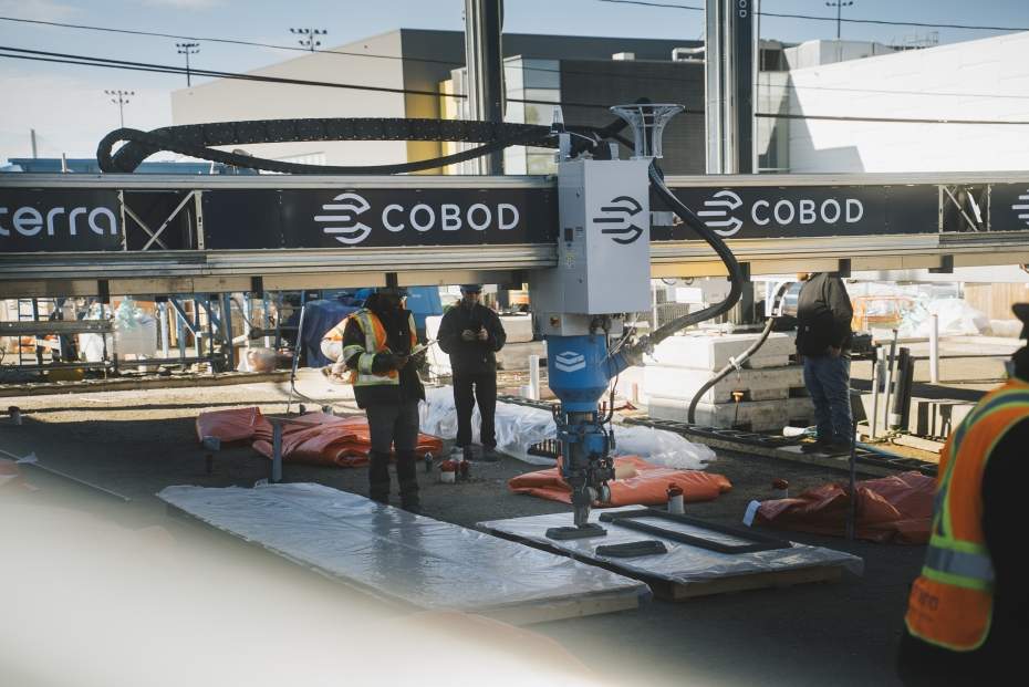 Workers operate a large-scale 3D printer on site at 1025 California Ave. as the University of Windsor begins construction on Canada’s first net-zero, multi-storey 3D-printed student residence.