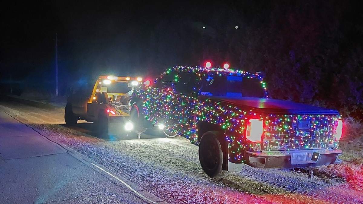 A holiday-decorated pickup is towed away after OPP say a 21-year-old driver was caught travelling more than 160 km/h on Brantford Road.
