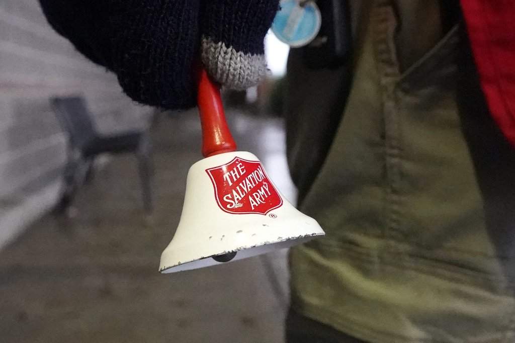 A Salvation Army bell is rung by the charity's red donation kettle in front of a grocery store, in Lynden, Wash., Tuesday, Dec. 8, 2020. THE CANADIAN PRESS/AP/Elaine Thompson.