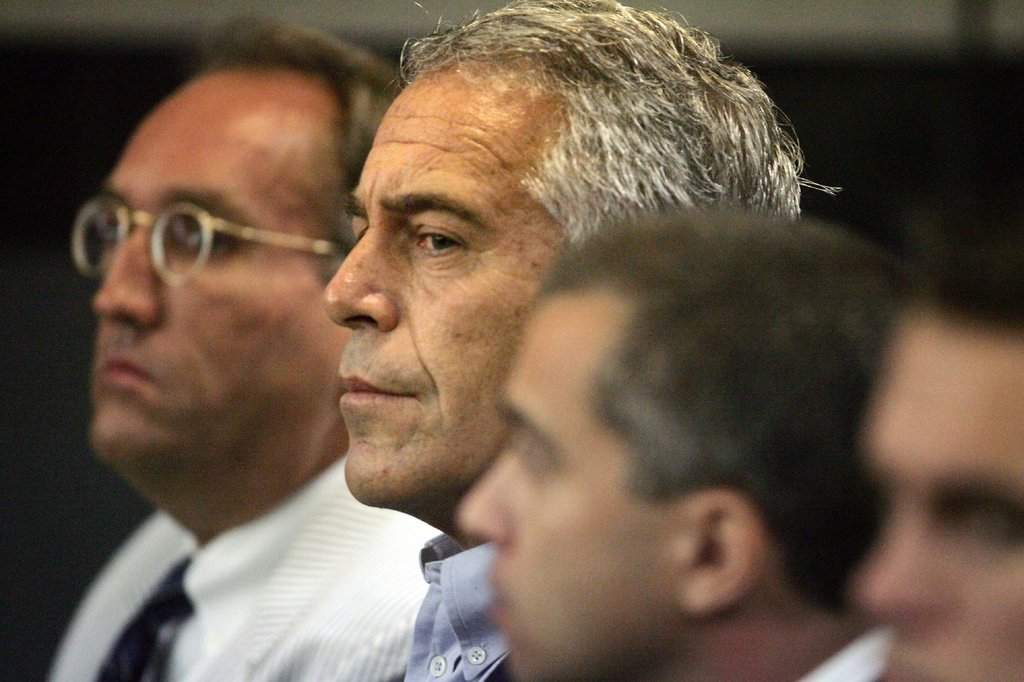 FILE - In this July 30, 2008, file photo, Jeffrey Epstein, center, appears in court in West Palm Beach, Fla.