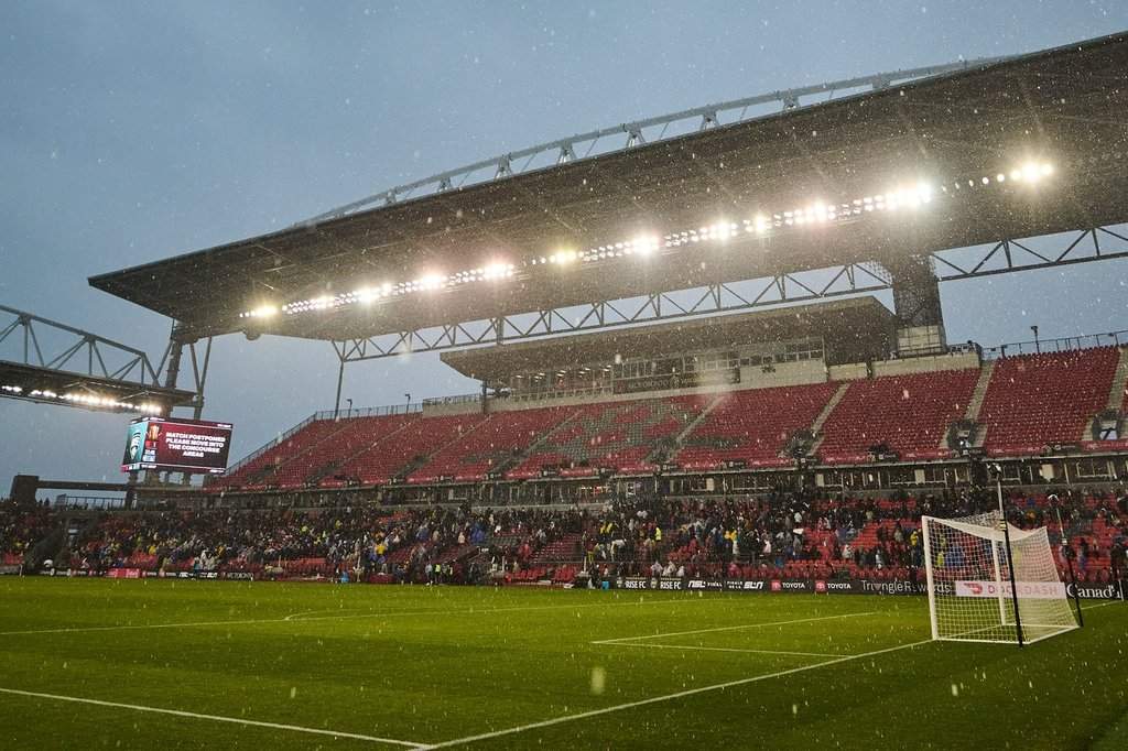Fans clear the stands in heavy rain after the match was postponed due to a weather delay during the first half of the 2025 NSL final in Toronto, on Saturday, Nov. 15, 2025. THE CANADIAN PRESS/Sammy Kogan.