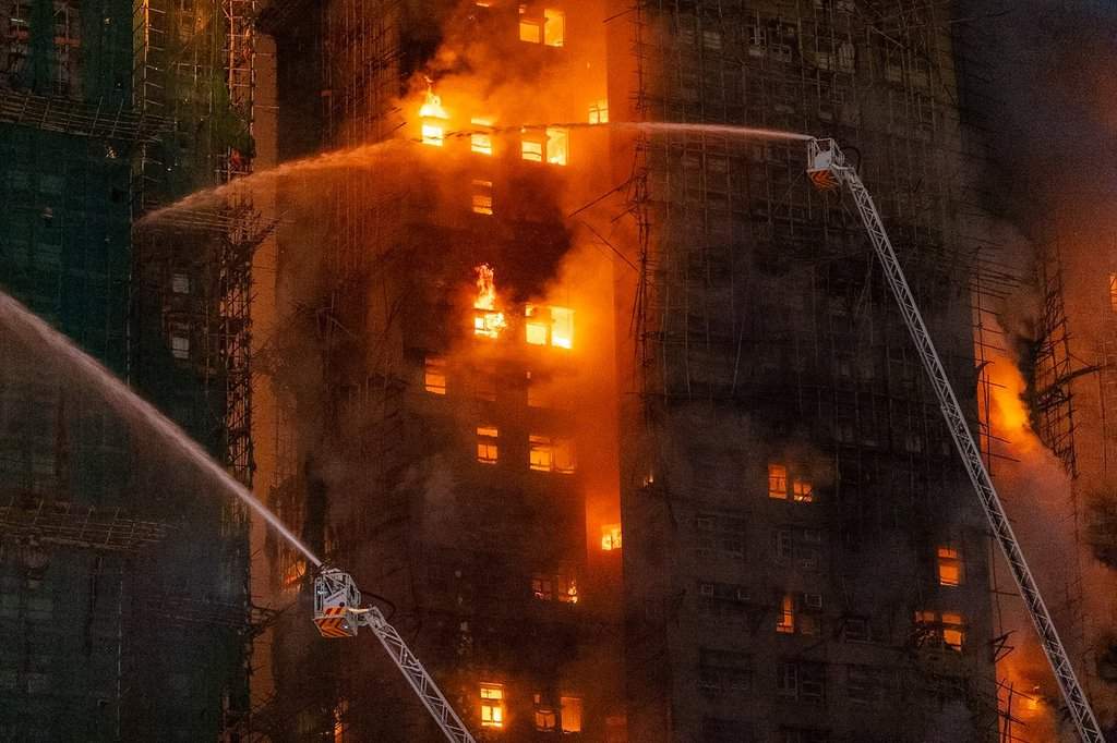 Firefighters try to extinguish a flames engulfing a building after a fire broke out at Wang Fuk Court, a residential estate in the Tai Po district of Hong Kong's New Territories, Wednesday, Nov. 26 2025.