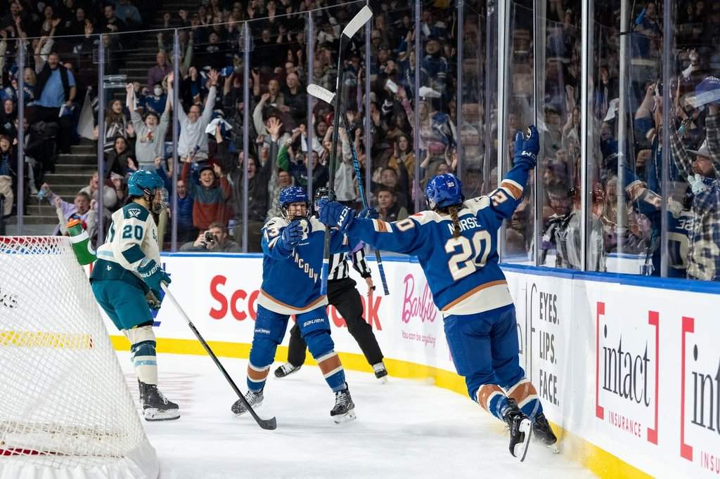 Vancouver Goldeneyes' Sarah Nurse (20) celebrates her goal with Michelle Karvinen (33) as Seattle Torrent's Mariah Keopple (20) watches during the first period of a PWHL hockey game in Vancouver, on Friday, November 21, 2025. THE CANADIAN PRESS/Ethan Cairns.
