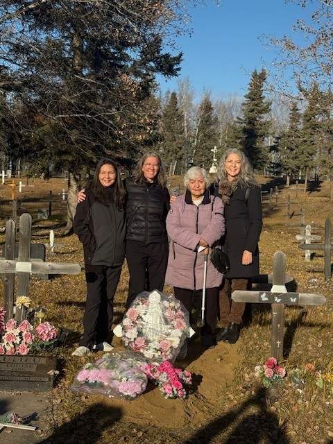 Delphine Beaulieu with her daughters at the burial site of her sister, Alma Beaulieu, who was exhumed from a residential school grave in Fort Resolution N.W.T. and repatriated to her home community in Fort Smith N.W.T. Alma Beaulieu was just five years old when she died in 1944. She is now buried next to her mother.