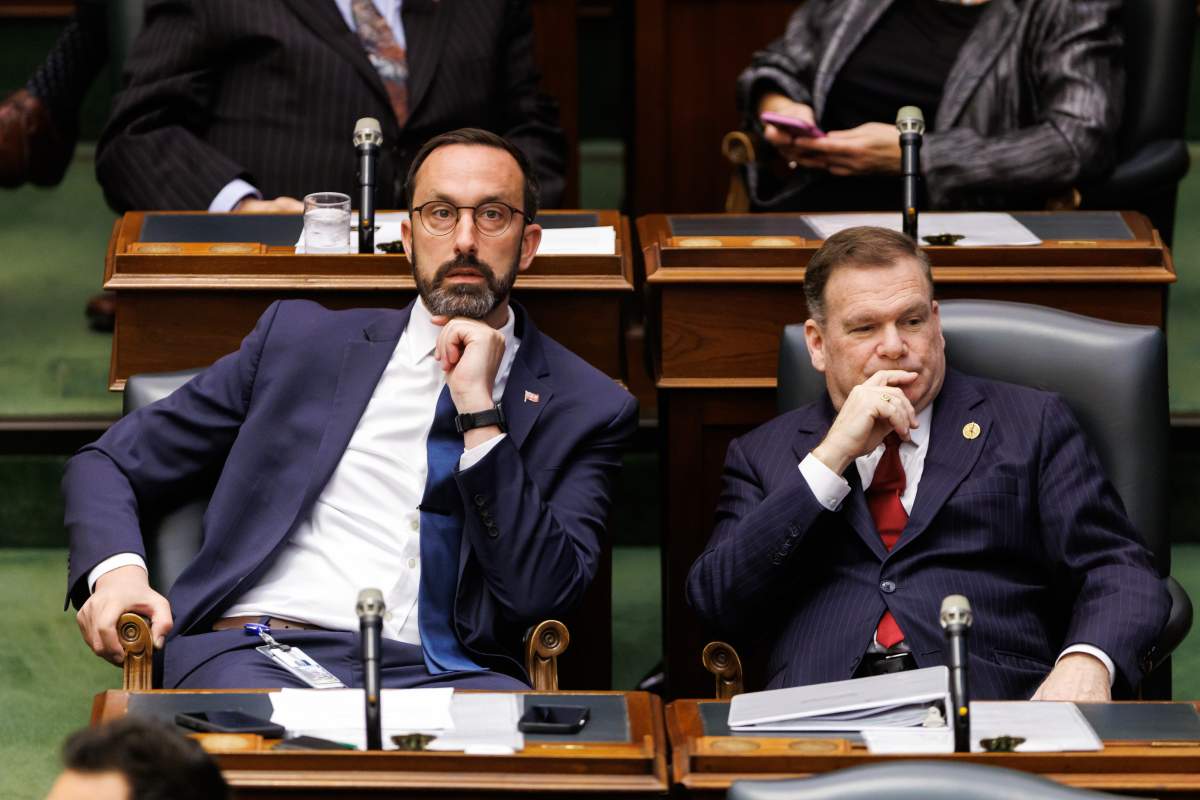 MPP's Nolan Quinn, left, and Todd McCarthy sit in the Ontario Legislature at Queen's Park in Toronto, Monday, April 14, 2025. 