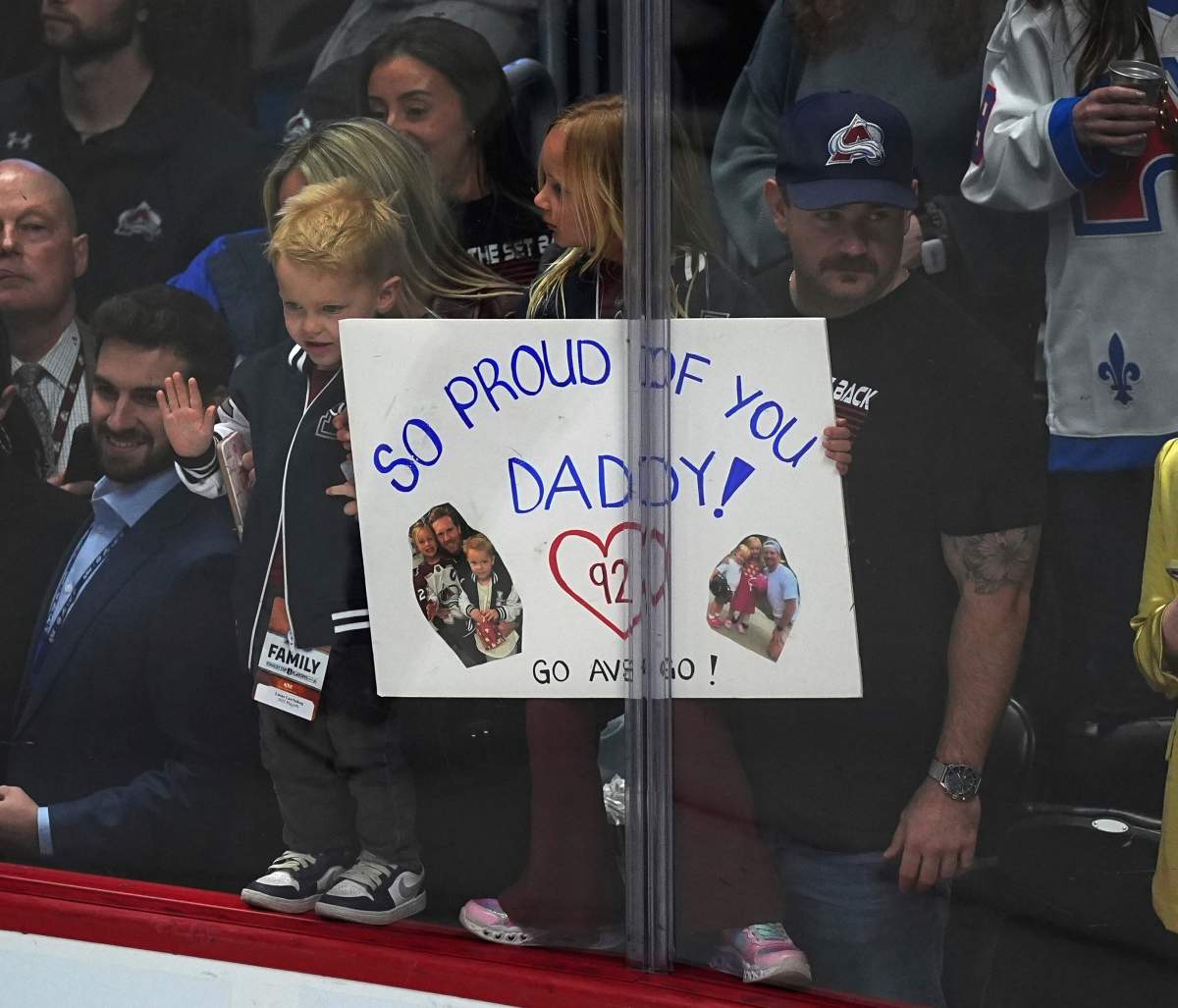 Family of Colorado Avalanche left wing Gabriel Landeskog holds placard as he warms up before the first period of Game 3 of an NHL first-round hockey playoff series against the Dallas Stars Wednesday, April 23, 2025, in Denver.
