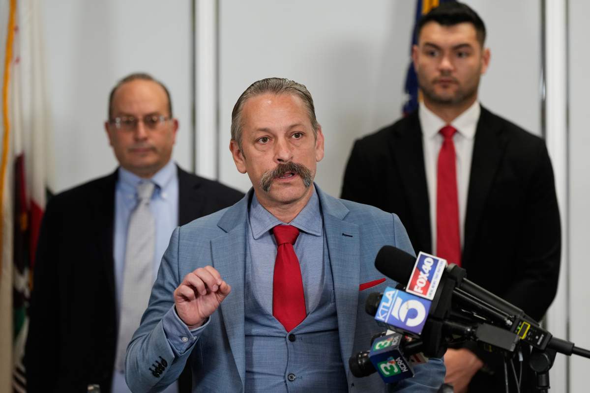 Attorney Mark P. Meuser, center, speaks to reporters during a press conference announcing a federal lawsuit challenging Proposition 50, Wednesday, Nov. 5, 2025, in Sacramento, Calif.