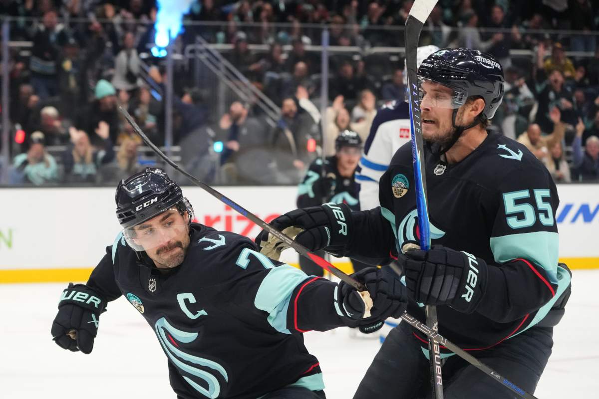Seattle Kraken right wing Jordan Eberle, left, celebrates scoring against the Winnipeg Jets with defenseman Ryan Lindgren (55) during the third period of an NHL hockey game Thursday, Nov. 13, 2025, in Seattle. (AP Photo/Lindsey Wasson).