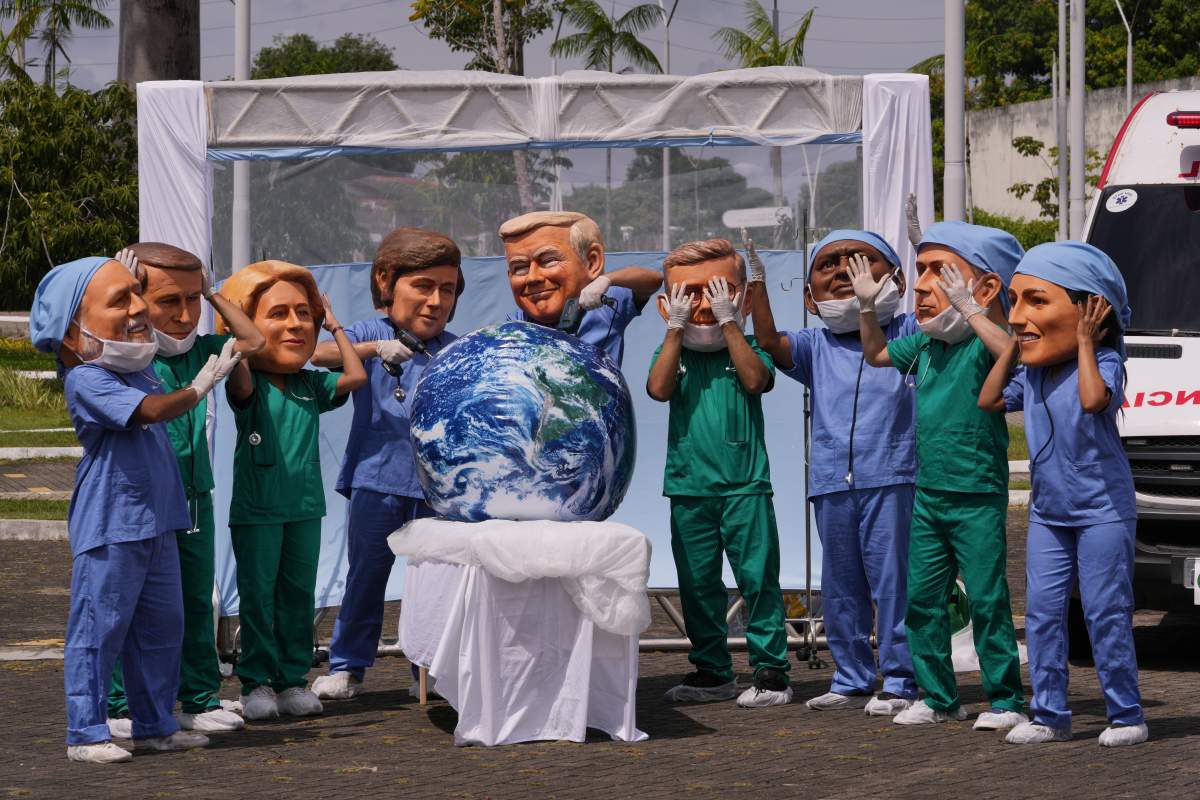 Demonstrators with the likeness of world leaders including President Donald Trump and Prime Minister Mark Carney (second from right), pretend to drill into the Earth during the COP30 U.N. Climate Summit, Thursday, Nov. 20, 2025, in Belem, Brazil. 