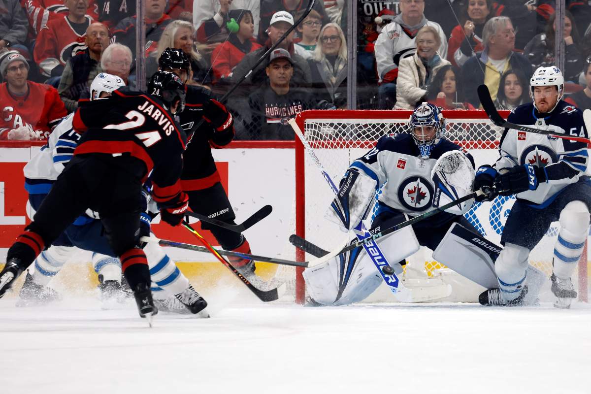 Carolina Hurricanes' Seth Jarvis (24) shoots the puck past Winnipeg Jets goaltender Thomas Milic (32) for a goal during the first period of an NHL hockey game in Raleigh, N.C., Friday, Nov. 28, 2025. 