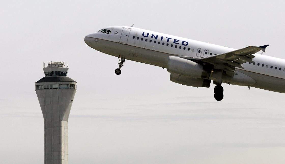 A United Airlines jet departs in view of the air traffic control tower at Seattle-Tacoma International Airport