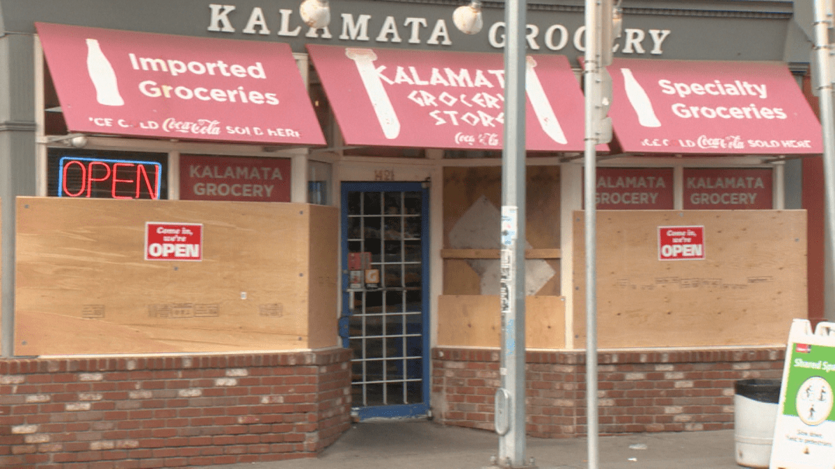 Windows of a Calgary business boarded up.