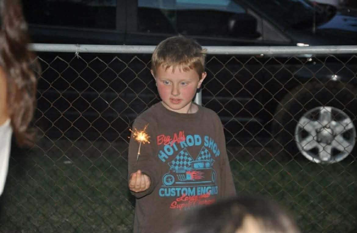 Undated photo of Caleb Berry as a child holding a sparkler.