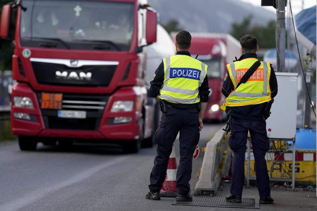 German federal police officers check trucks at the Austrian-German border crossing point in Kiefersfelden, Germany, Monday, Oct. 9, 2023. (AP Photo/Matthias Schrader).