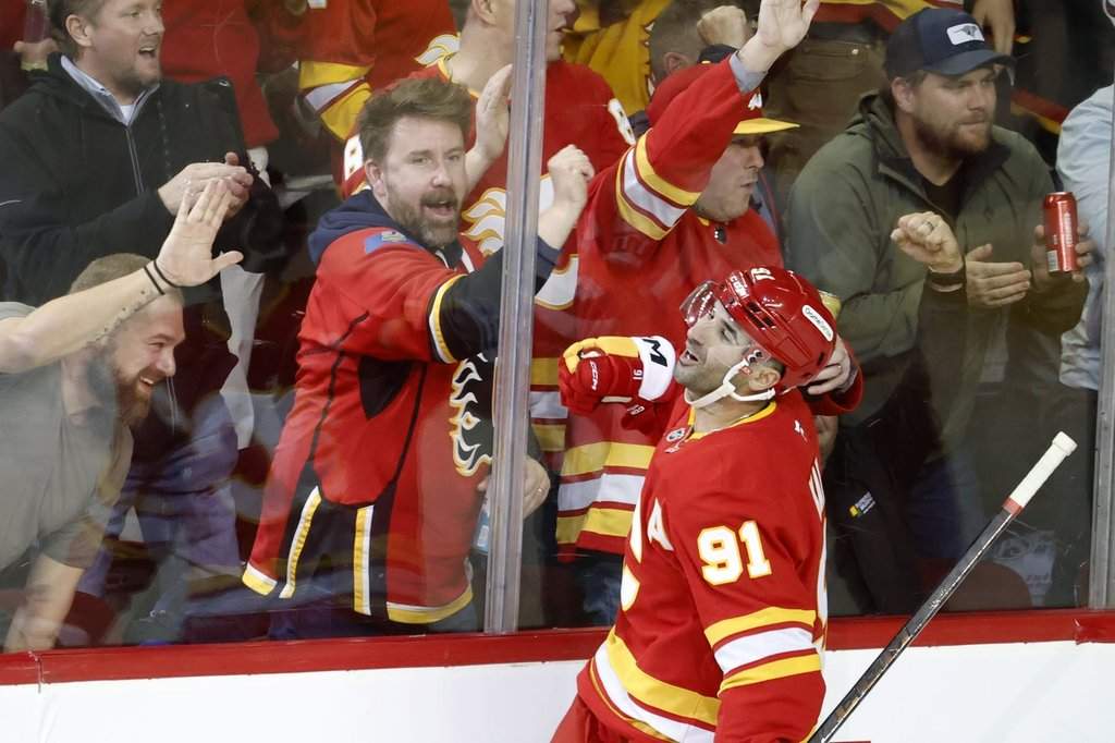 Calgary Flames' Nazem Kadri and fans celebrate his goal against the Columbus Blue Jackets during second period NHL hockey action in Calgary on Wednesday, Nov. 5, 2025.
