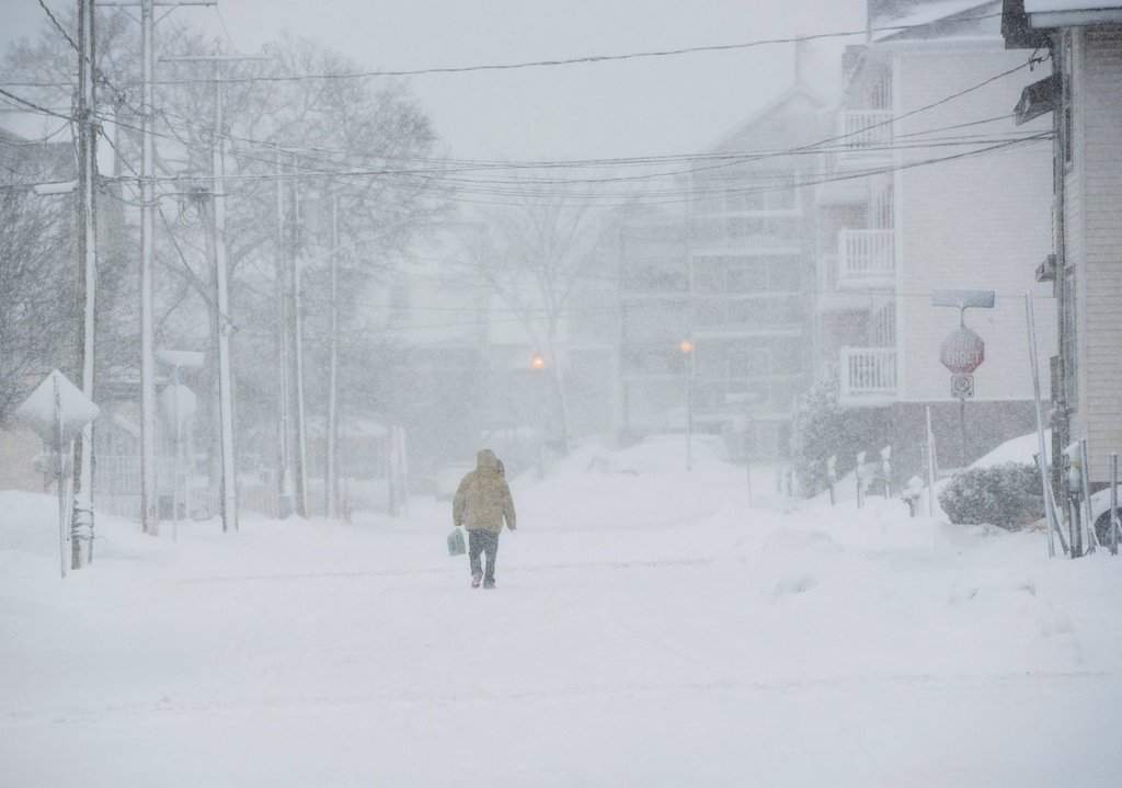 A pedestrian walks down the middle of the road on Victoria Street in downtown Moncton, N.B., on Thursday, Jan. 4, 2018.