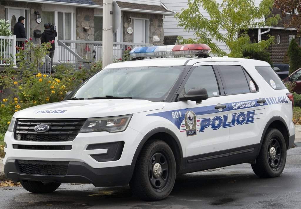 A police vehicle is shown outside a house in Laval, Que., Tuesday, Oct. 18, 2022. THE CANADIAN PRESS/Ryan Remiorz.