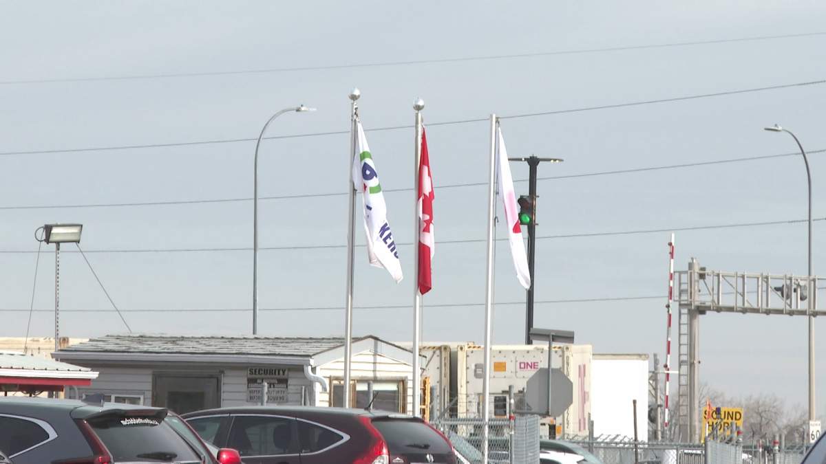 The Canada Packers flag (left) flies outside the company;s pork processing plant in Lethbridge, Alta.