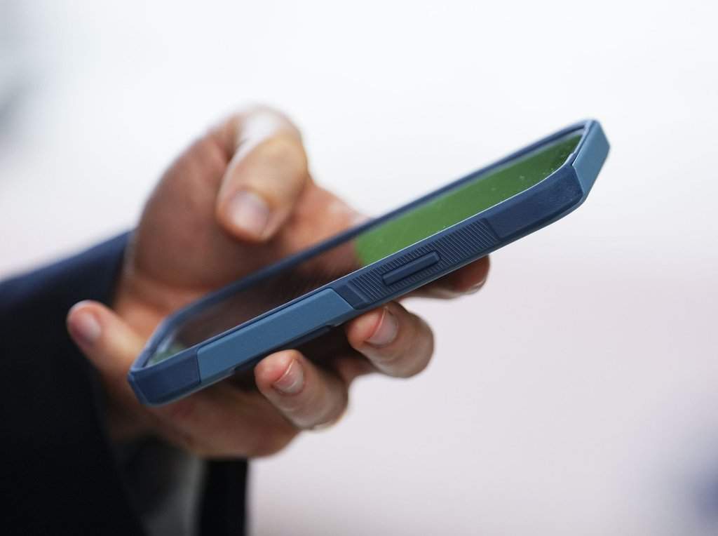 A person uses a mobile phone in Ottawa in this July 18, 2022, photo. The Canadian Press/Sean Kilpatrick.