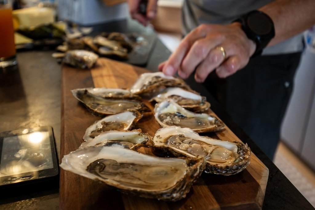 Oysters are seen on a serving board
