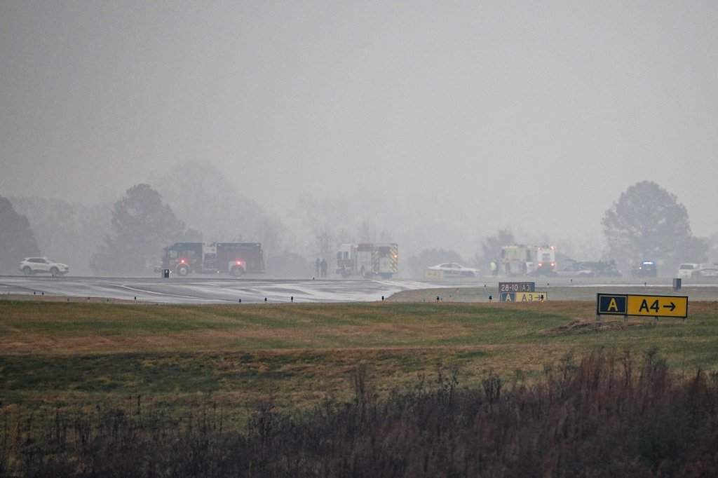 First responders tend to the scene of a reported plane crash at a regional airport in Statesville, N.C., Thursday, Dec. 18, 2025. (AP Photo/Matt Kelley).