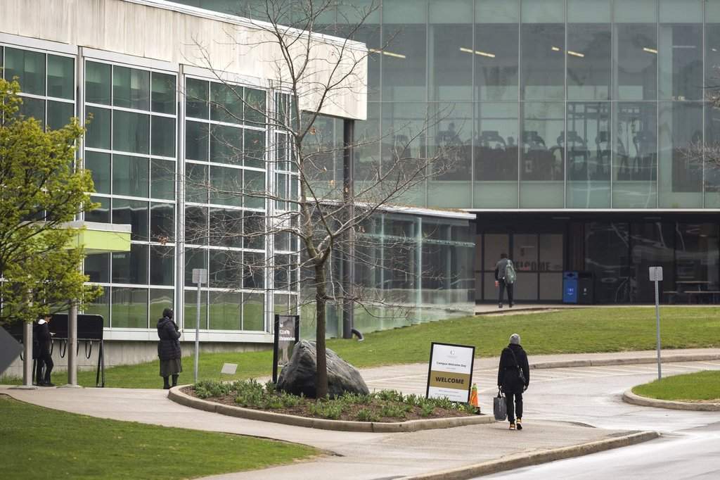 Students walk on the Conestoga College campus in Kitchener, Ont., Saturday, April 27, 2024. THE CANADIAN PRESS/Nick Iwanyshyn.